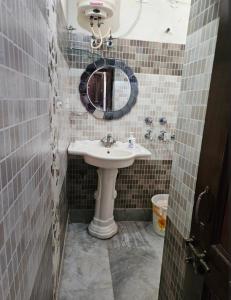 a bathroom with a sink and a mirror at Hotel nitin in McLeod Ganj