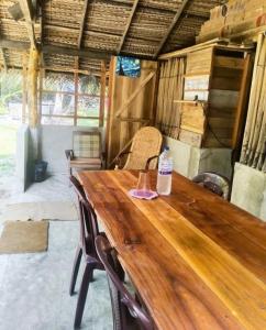 a wooden table with two chairs and a bottle of water on it at Delft Cultural Home Stay in Delft East