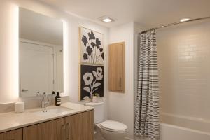 a bathroom with a toilet and a sink and a shower at Avelle in Mountain View +10 photos
