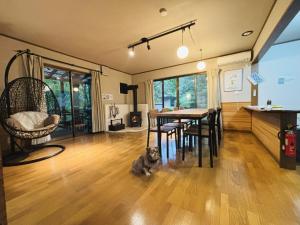a dog sitting on the floor in a living room at Villa Foresta TERU in Nasu