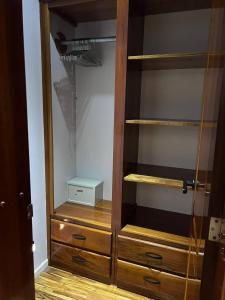 a closet with wooden shelves and a box in it at Luxurious Rainforest Retreat in Drake Bay, Osa, Costa Rica in Drake