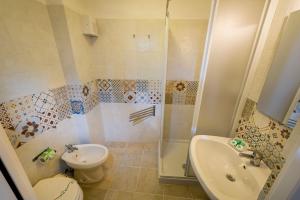 a bathroom with a shower and a toilet and a sink at Affittacamere Amunì in Castellammare del Golfo