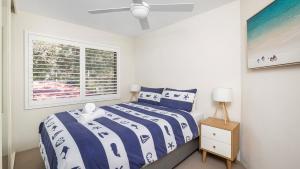 a bedroom with a bed and a window at The Poplars Apartment Nelson Bay with Swimming Pool in Nelson Bay +10 photos