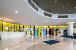 a lobby of a building with yellow and green walls at Holiday Inn Express Yangzhou City Center By IHG in Yangzhou +63 photos