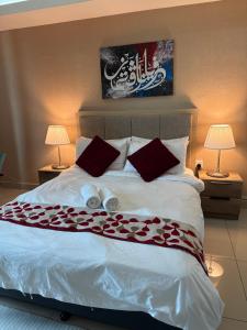 a bedroom with a large bed with two lamps at The Viana Apartment 1 in Kota Bharu