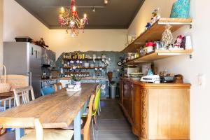 a kitchen with a large wooden table and a dining room at Traumhaftes GARTENLOFT in Marienberg