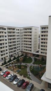 a parking lot with cars parked in front of large buildings at Apartment in Ploiești 4 in Ploieşti