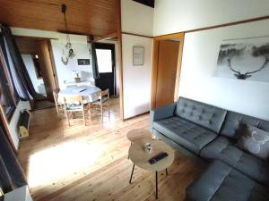 a living room with a couch and a table at Wald Chalet Nr 2 in Kellenhusen