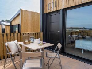 a patio with a table and chairs on a balcony at Resort Natur O Grove in O Grove