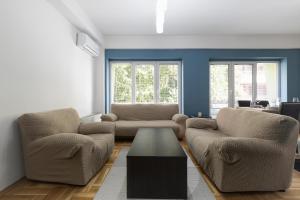 a living room with two chairs and a coffee table at APT Near Millenium Cross,Clinical Center Mother Teresa, City-Center,Free Parking in Skopje