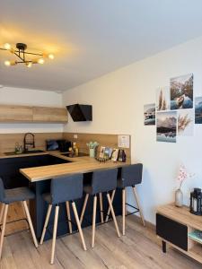 a kitchen with a large wooden table and chairs at Cocon Des Bois - Gex Genève Mijoux in Mijoux