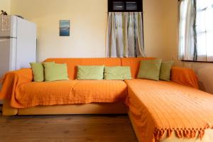 an orange bed with green pillows in a room at Zeusplace Kallithea Park near Olympic Beach in Vromerí