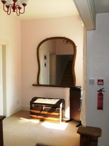 a mirror on a wall in a room with a table at Bridge House Bed & Breakfast in Newark upon Trent