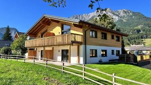 een huis op een heuvel met een hek bij dein Dahoam Boutique Appartements in Gröbming