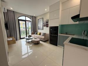 a kitchen and living room with a couch and a table at Three women in Phu Quoc
