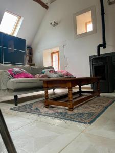 a living room with a couch and a coffee table at loft à la campagne in Vermenton