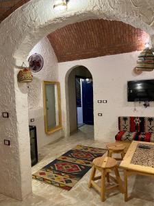 a living room with a table and a couch at Bait Gamal Siwa بيت جمال سيوة in Siwa
