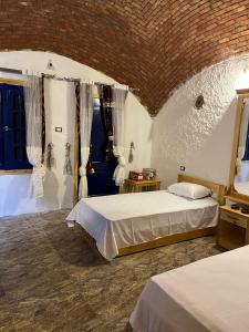 a bedroom with two beds in a room at Bait Gamal Siwa بيت جمال سيوة in Siwa