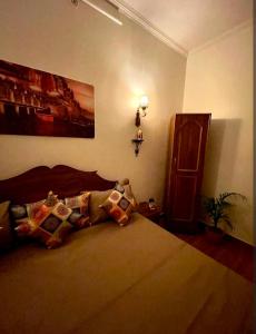 a bedroom with a bed and a painting on the wall at Hotel Neeraj in Morādābād