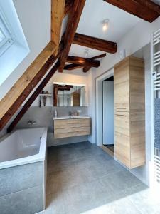 a bathroom with a sink and a bath tub at Dornröschen-Loft in Marienberg