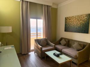 a living room with a couch and a table at Royal View Hotel in Ras al Khaimah