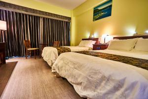 Postel nebo postele na pokoji v ubytování Serenti Hotel Saipan