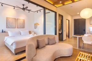 a bedroom with a bed and a couch at 22 Macalisterz by ALV in George Town