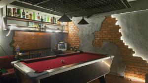 a pool table in a room with a brick wall at bonheur house betong in Betong