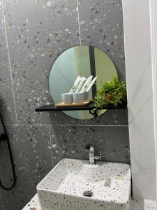 a bathroom with a sink and a mirror at Bảo Bối House in Cao Lãnh +20 photos