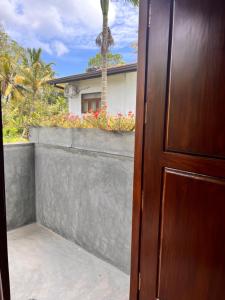 a door leading to a balcony with a house at Melon Guest - Weligama in Weligama