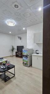 a living room with a table and a kitchen at Bu studio 46 Nam Ngư in Hanoi