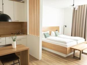 a bedroom with a bed and a desk in a room at Haus NordQuartier in Norderney