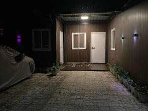 a room with a white door and a room with plants at Ays homestay in Puerto Princesa City