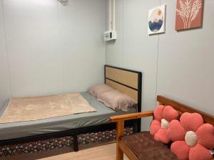 a small room with a bed and a bench at Ays homestay in Puerto Princesa City