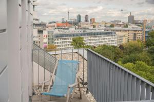 a blue chair sitting on the balcony of a building at Motel One Berlin-Tiergarten in Berlin