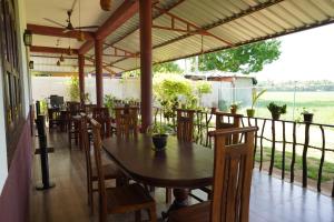 a dining area with a table and chairs in a restaurant at Lavender Home Yala Safari in Tissamaharama