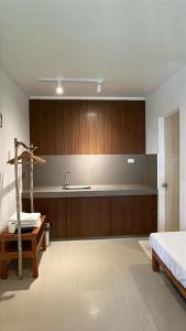a bathroom with a sink and a bed and a counter at NAYANAYA Villas Siargao in General Luna