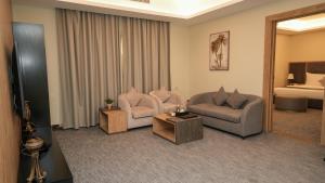 a living room with two chairs and a couch at بنزرت للشقق الفندقية in Al Hofuf +134 photos