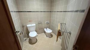 a bathroom with a toilet and a bidet at Schonen House by Ruby Living in Yogyakarta