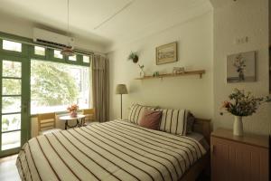 a bedroom with a large bed and a window at Langmandi Experience Ấu Triệu in Hanoi