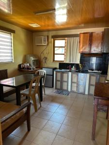 a kitchen with a table and a dining room at Ina Homestay in Coron