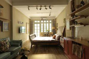 a living room with a bed and a couch at Langmandi Experience Ấu Triệu in Hanoi