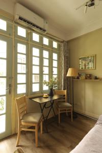 a room with a table and chairs and a bed at Langmandi Experience Ấu Triệu in Hanoi