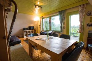 a dining room with a wooden table and chairs at BERG WELT im Erzgebirge in Marienberg