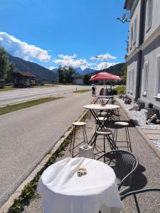 two tables and chairs on the side of a road at Locanda EL TORO in Arnoldstein