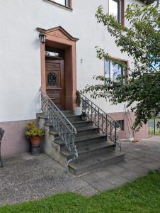 a set of stairs in front of a building with a door at Ferienwohnung am Eifelsteig in Üxheim