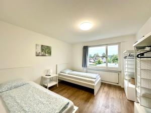 a bedroom with two beds and a window at Monteurzimmer - Worker's accommodation - ZIMMERzuVERMIETEN in Deitingen Neumatt in Deitingen