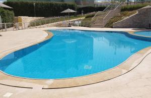 une grande piscine avec de l'eau bleue dans l'établissement Janna new furnished luxury wide apartment the, à Sheikh Zayed