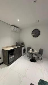 a kitchen with a table and chairs and a stove at Sohob Compound in Al Khobar