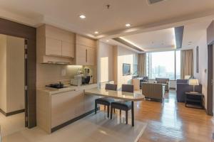 a kitchen and living room with a table and chairs at Jasmine Resort Hotel Bangkok BTS Phrakhanong in Bangkok